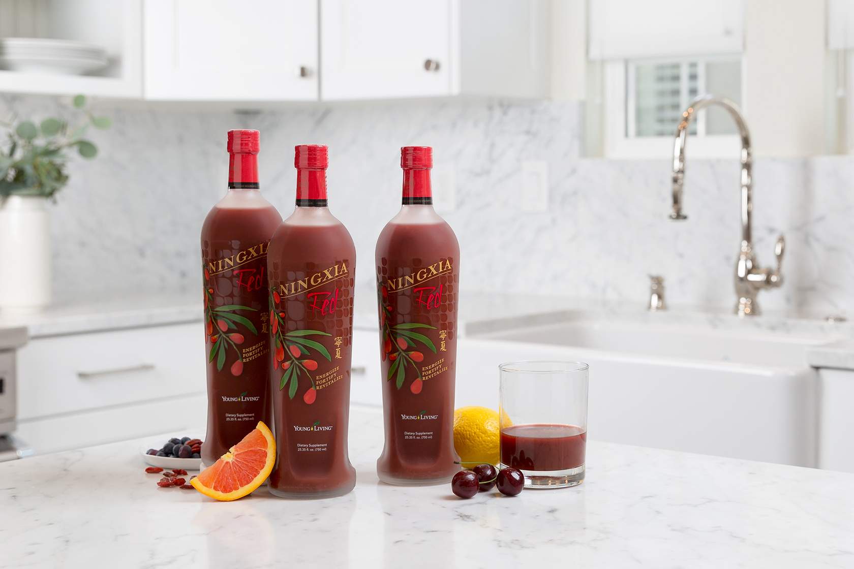 three ningxia red bottles and a glass of ningxia