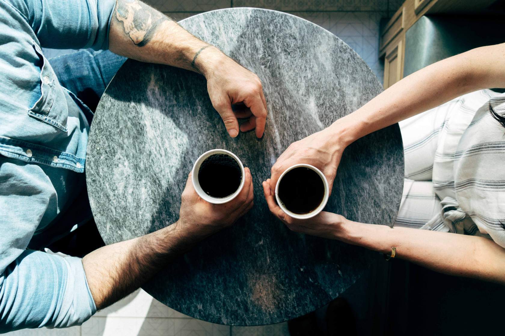 two people drinking coffee